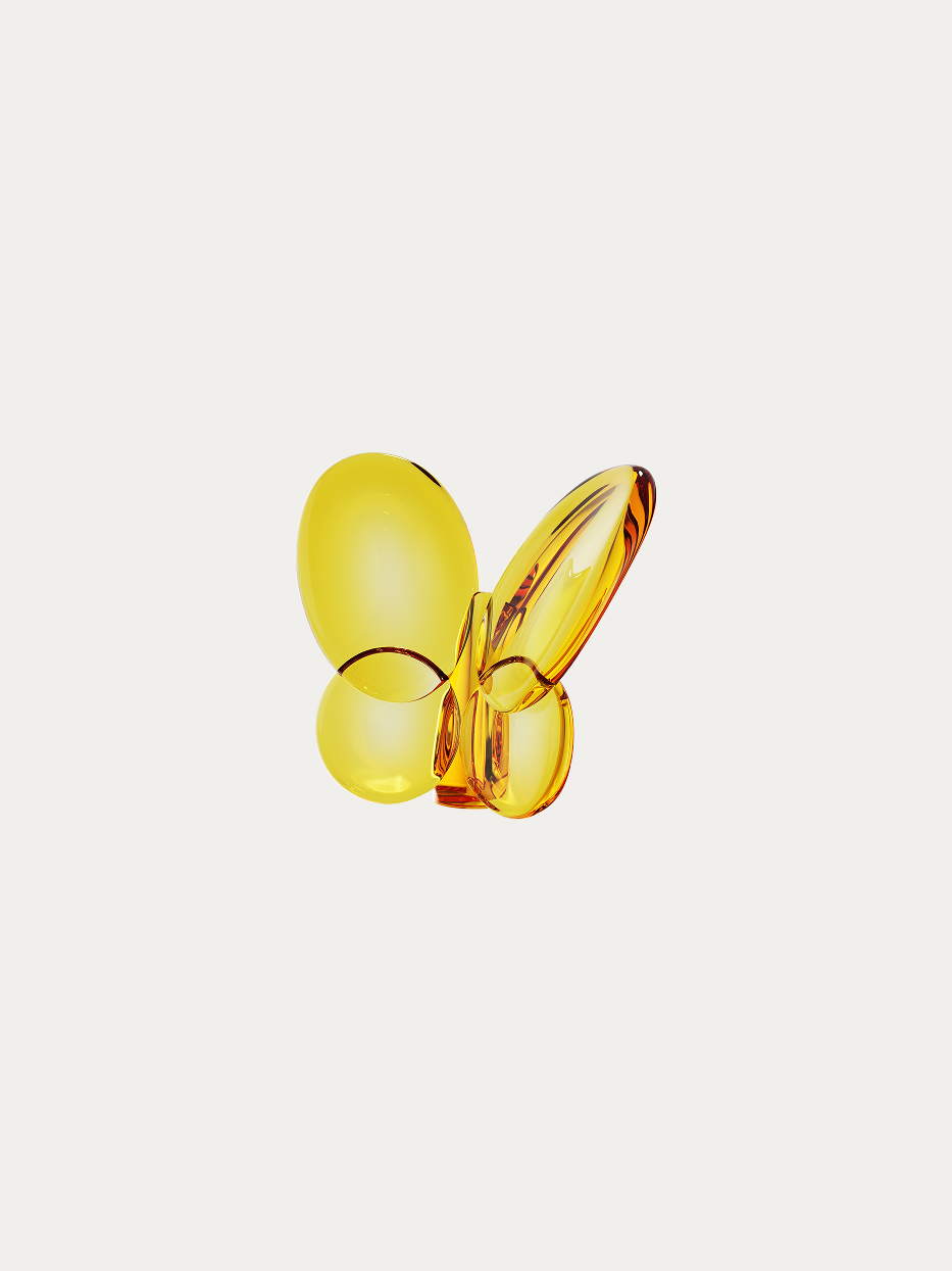 Official product shot of amber crystal butterfly ornament on pure off-white background, integrated smooth butterfly curved shape, full transparent amber yellow crystal, all edges hand-polished soft light luxury decorative ornament
