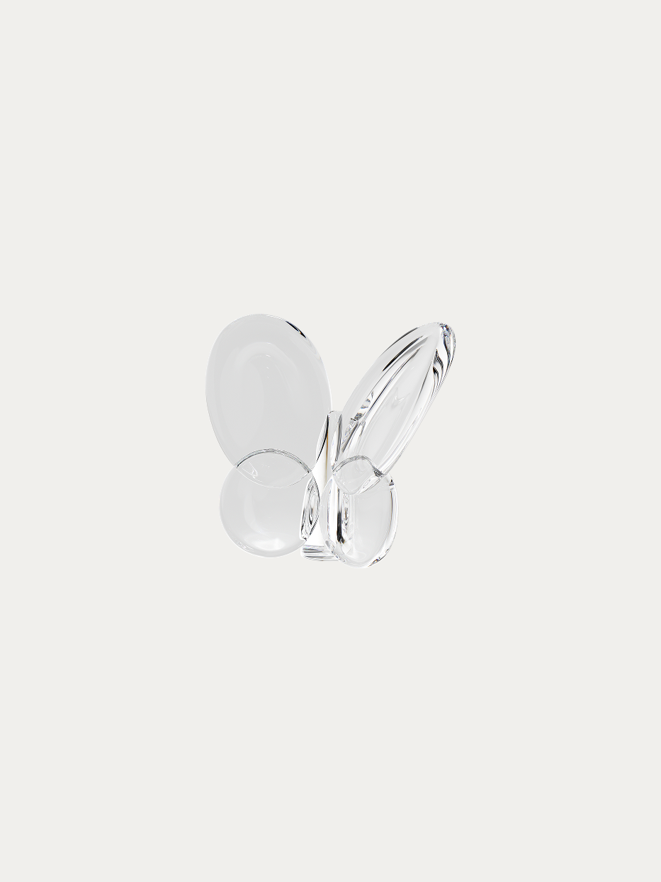 Official product shot of clear crystal butterfly ornament on pure off-white background, integrated smooth butterfly curved shape, full impurity-free transparent crystal, all edges hand-polished versatile minimalist decorative ornament
