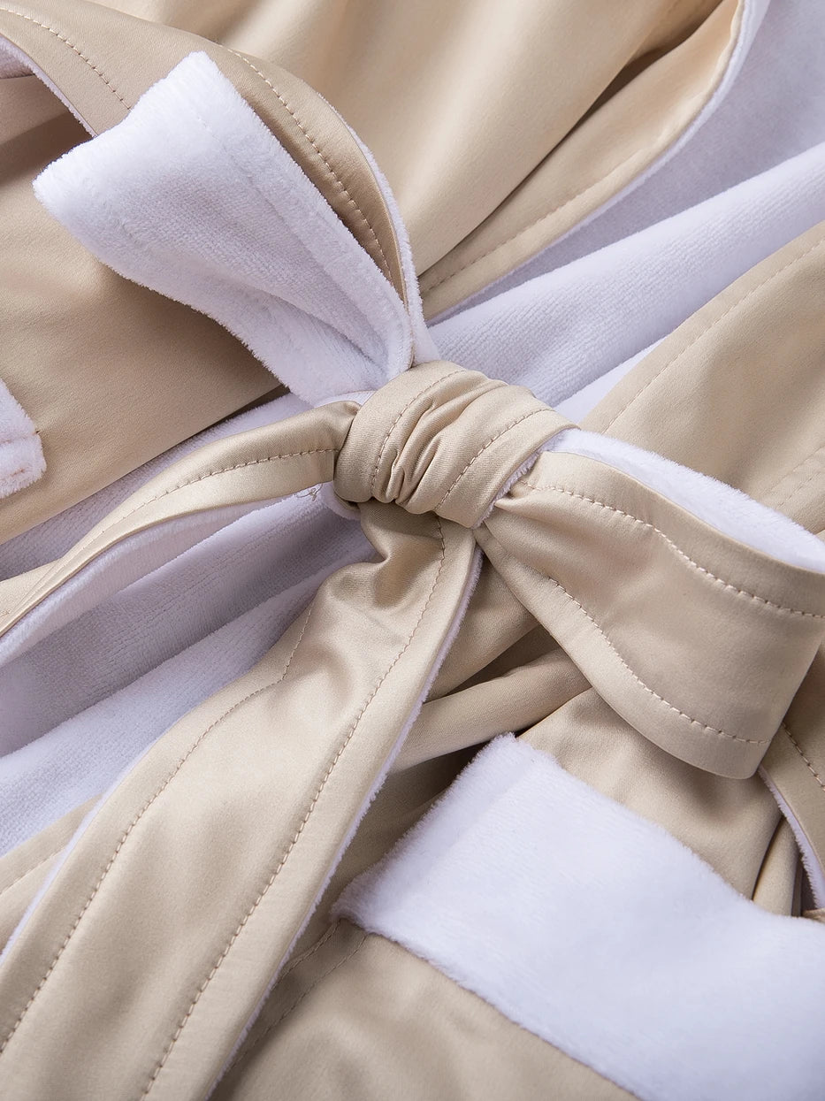 Macro close-up of waist tie joint craft of HERA double-layer bathrobe, contrast composite structure of amber polyester outer and white cotton inner, neat uniform stitching, firmly bonded double layers resistant to delamination and loose threads