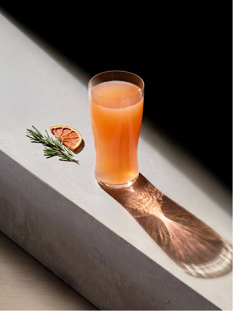 Official lifestyle image of the RESONG 1833 Tall Glass (Pair), featuring elegant crystal drinkware with a sculpted silhouette for juice, cocktails, and contemporary dining.
