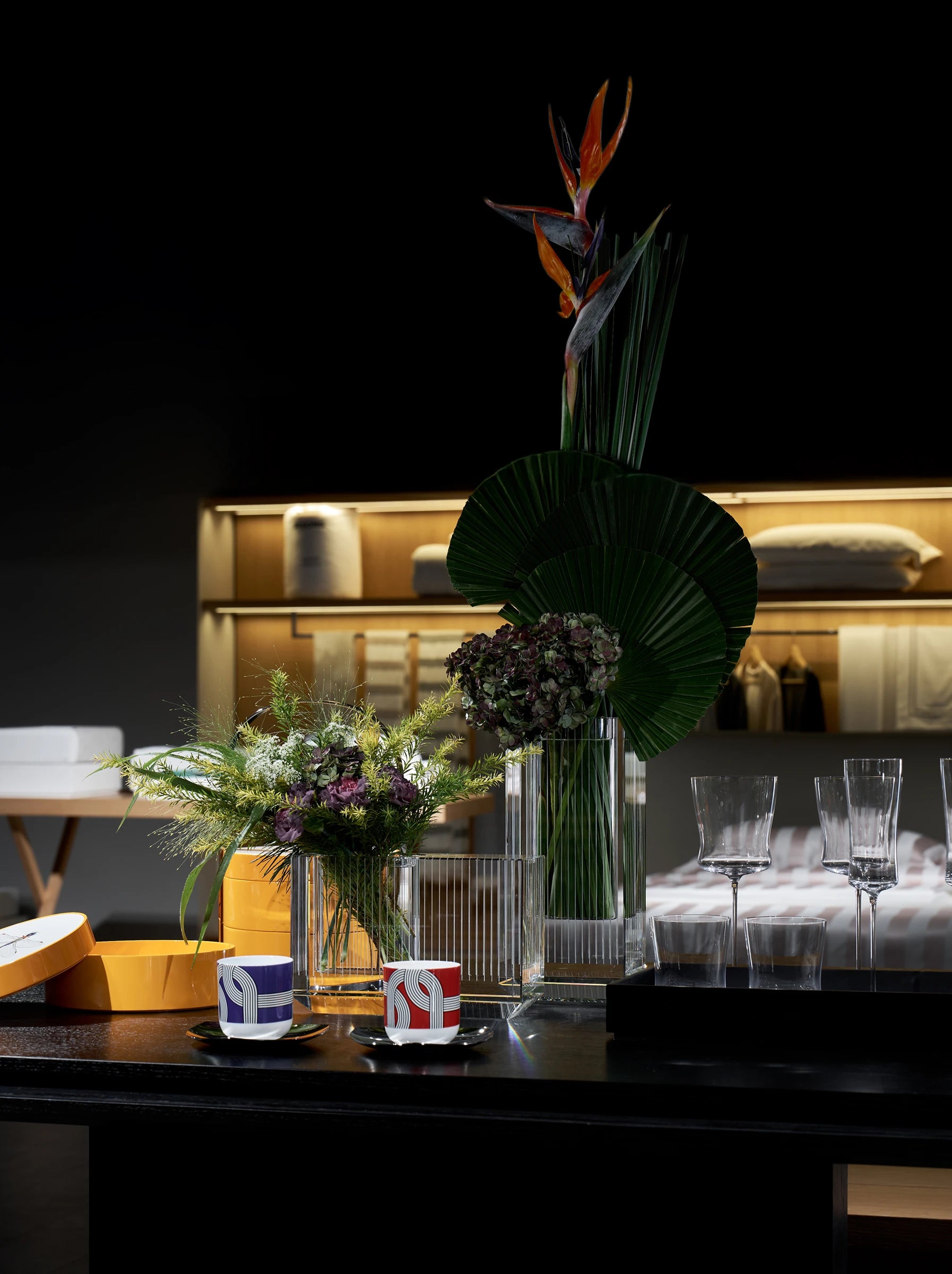 RESONG Home handcrafted crystal vases and lacquer decor tabletop close-up, showcasing XUYU Vase Collection high-transparency cubic crystal vases with bird of paradise floral, DRAGONFLY Storage Collection lacquer boxes, ALK Collection signature ceramic cups and 1833 Collection crystal stemware. Mouth-blown crystal & traditional lacquer craft, suitable for living room centerpiece, entryway console decor, premium gift set display, luxury home styling