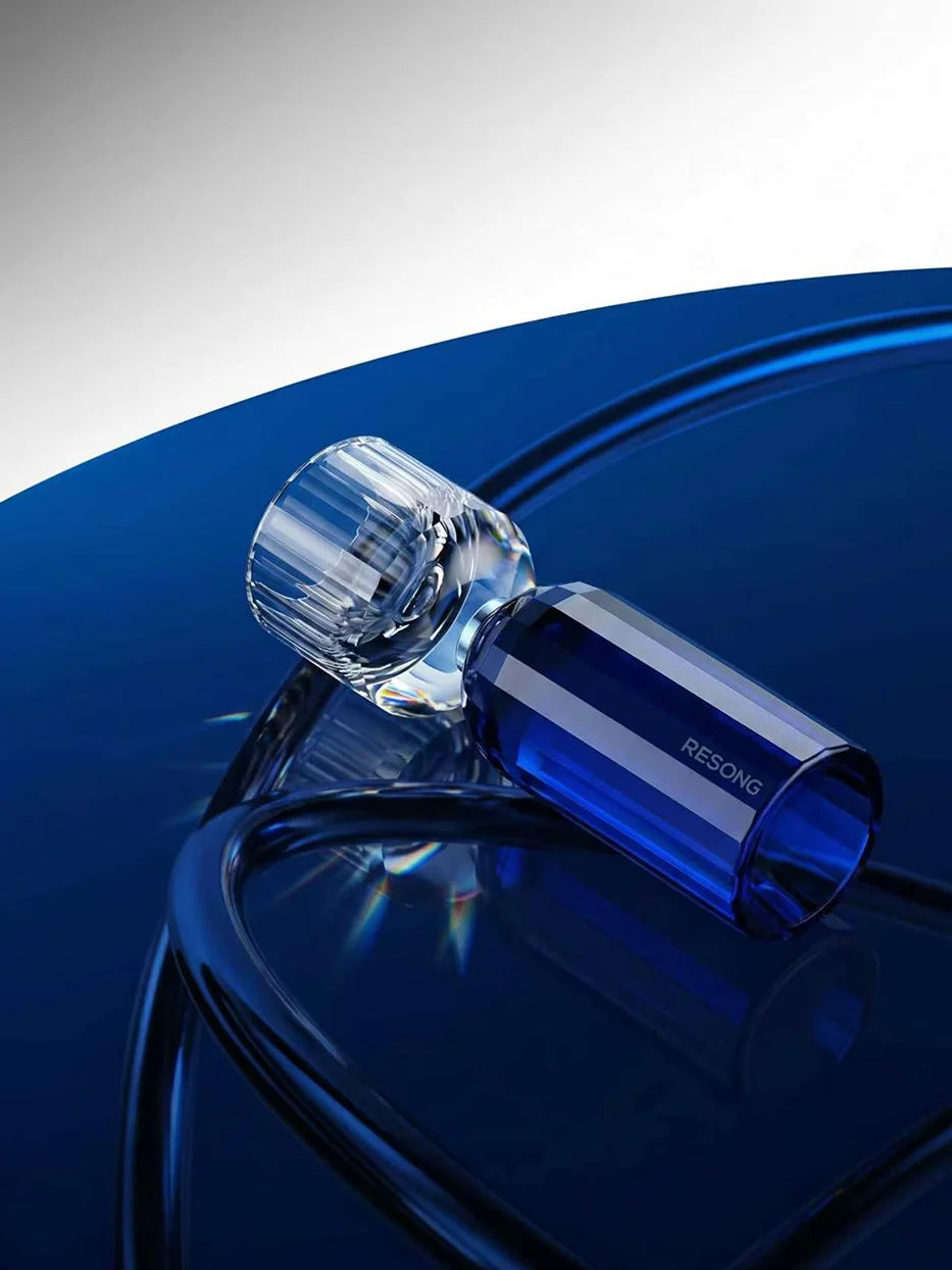 Minimal studio close-up of single HAOYING dual-layer blue base shot glass, gradient sapphire blue curved background highlighting hand cut crystal facets