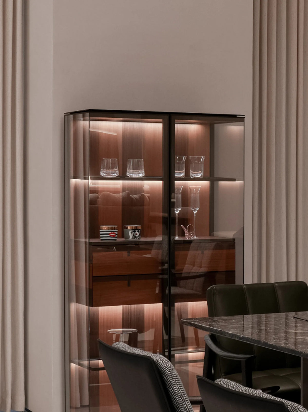 RESONG Home LED-lit tempered glass display cabinet for dining room side storage, showcasing premium barware including POP Collection decorative cups, TRIUMPH Whiskey crystal glassware and XUYU hand-carved tumblers. Dark metal frame with warm ambient lighting, perfect for home mini bar, dining sideboard decor, luxury glassware display solution