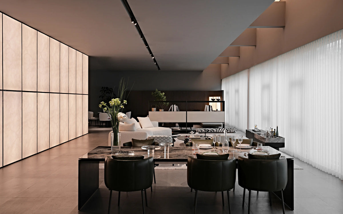 RESONG Home modern luxury open-concept dining and living room full panorama, dark marble dining table with curated tableware arrangement, featuring XUYU Vase Collection high-clarity cubic crystal vase, ERYA Collection high-temperature porcelain dinnerware, R Collection stainless steel cutlery, STARLIGHT lead-free crystal fruit plate and DRAGONFLY Storage lacquer boxes. Sleek minimalist interior, ideal for villa dining spaces, luxury model home soft furnishing, high-end residential decor inspiration