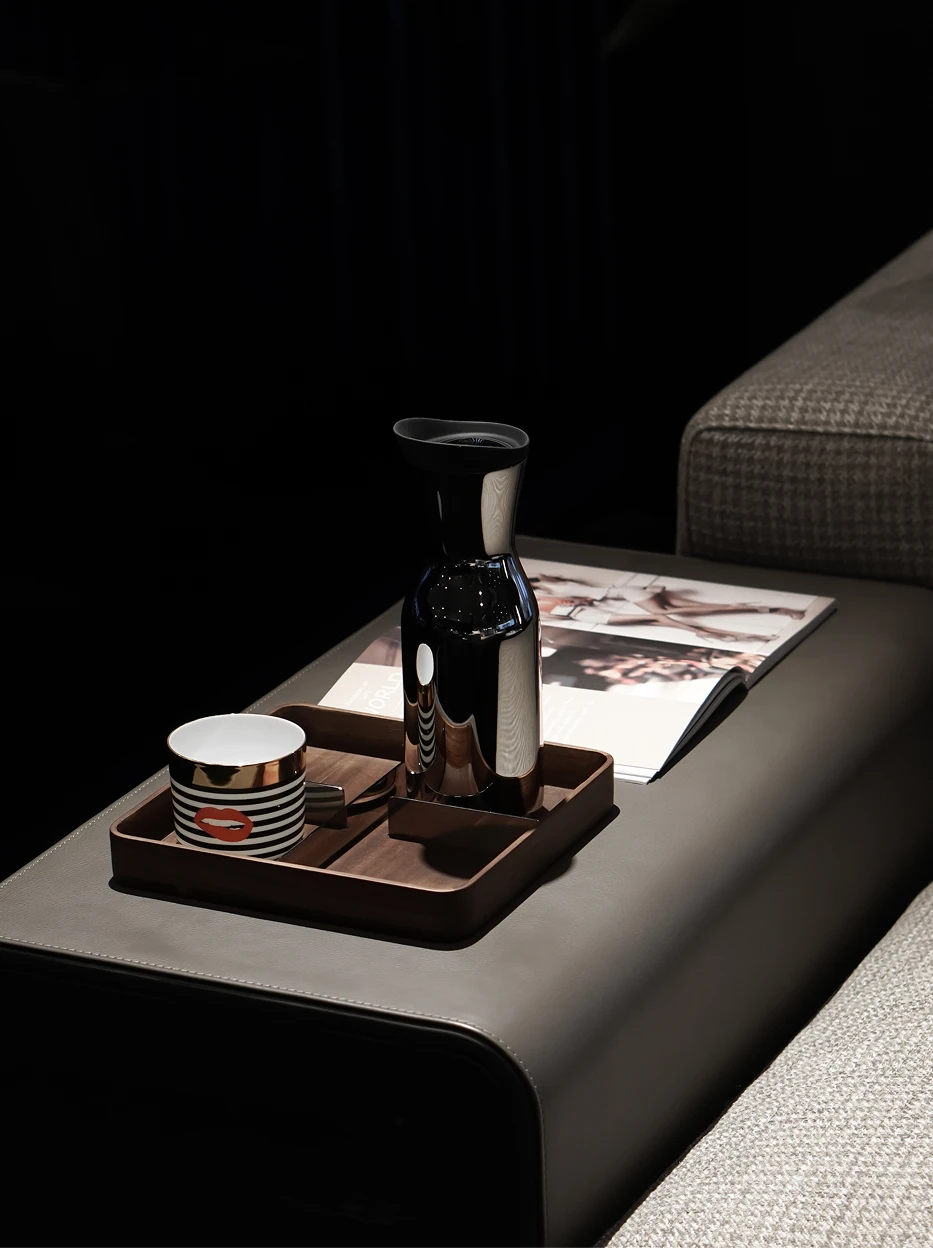 Modern light luxury living room shot of POP Art Red Lips ceramic cup on divided walnut wood tray, matched with metal carafe and fashion magazines beside grey fabric sofa