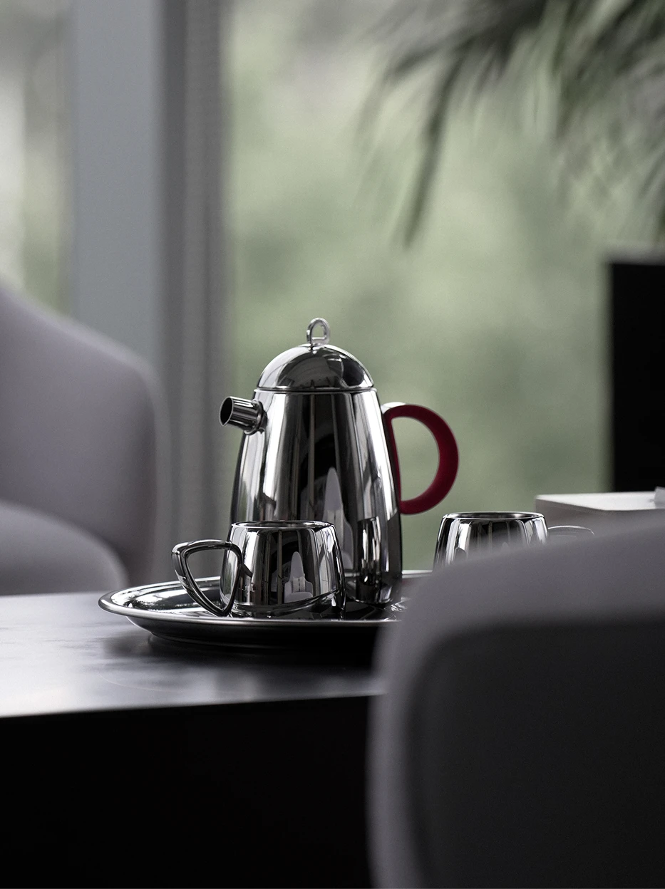 Home lifestyle shot of large SHEDI red handle teapot on metal tea tray matched with matching stainless steel cups beside light grey fabric sofa beside window