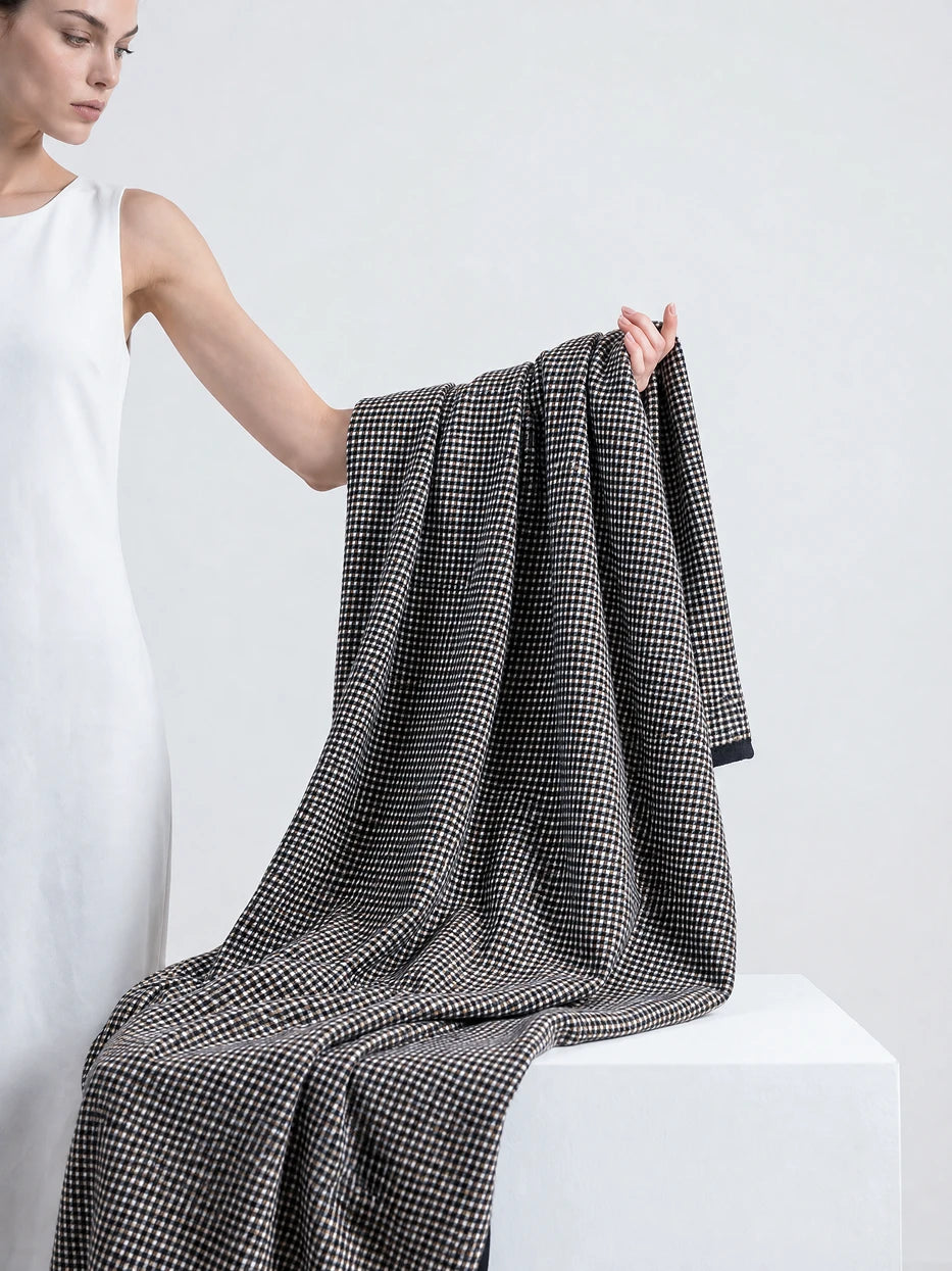 Pure white background half portrait shot of model holding unfolded LUODI retro check cashmere blanket, demonstrates multi-scene usage as wearable shawl, office nap cover, daily commute wrap, lightweight soft wool viscose blend fabric all season friendly, minimalist high-end wearable home textile for daily rest and travel