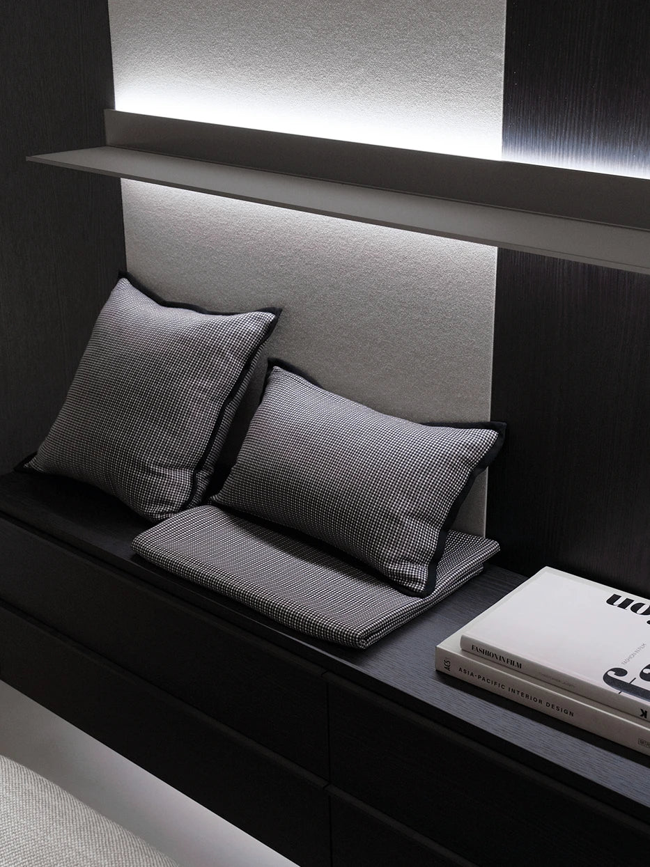Dark minimalist bedroom combo furnishing layout shot, LUODI tiny check cashmere lumbar pillow matched with square cushion stacked on dark floating wood cabinet, retro fine check texture adds delicate layered detail to heavy dark furniture, premium decor for villa bedroom, homestay suite, large flat bedroom, dark neutral tone interior styling