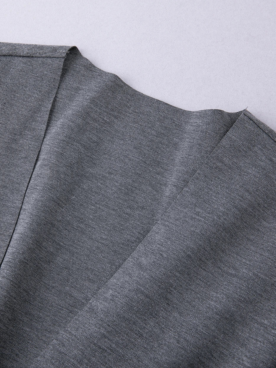 Macro close-up of kimono V-lapel joint of MAYA stretch bathrobe, integrated solid fabric seamless splicing craft, neat uniform lock stitching, displays precise well-fitted minimalist craft of single-layer knit fabric