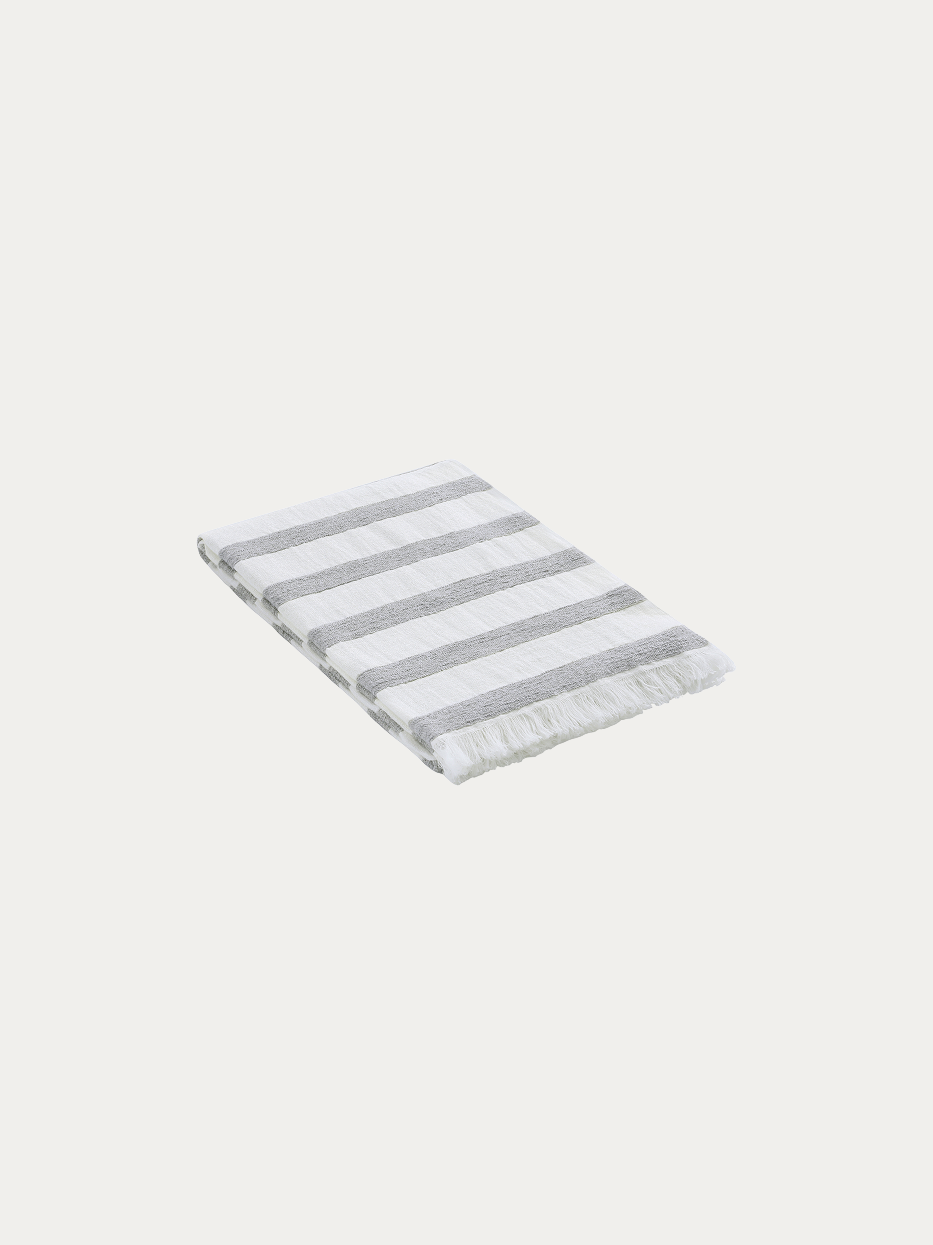 Official flat lay product shot of MUJIE Gray Linen Blanket in pure off-white background, oversized throw blanket with horizontal grey-white textured stripes, natural handmade tassel fringes on four edges, blended fabric of 64% linen, 5% wool, acrylic and polyester, breathable warm multi-purpose decorative cover, ideal for sofa, bed end, window seat, office nap, beach wrap, suits wabi-sabi, Nordic, minimalist, cream and mid-century home decor