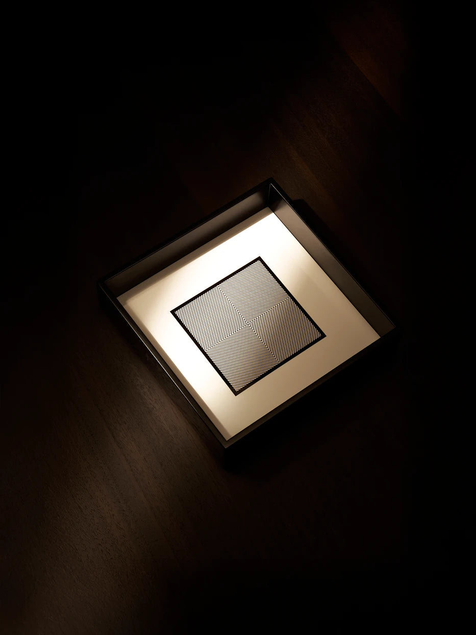 Top-down minimalist texture shot of empty medium black square tray on dark wood grain table, side light highlighting glossy black rim and inner geometric texture