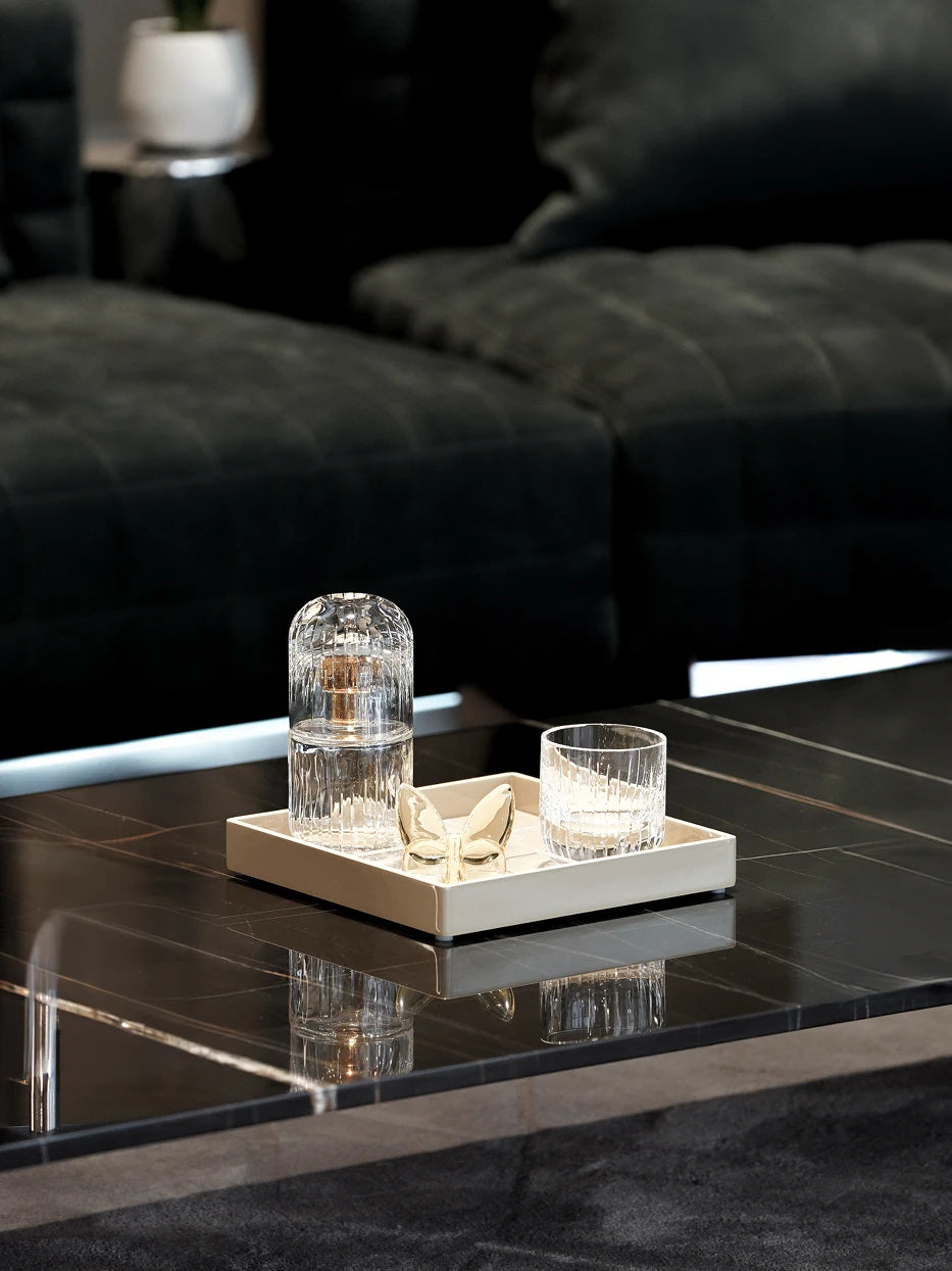 Italian light luxury dark tone furnishing shot of khaki four-compartment tray on black reflective marble coffee table
