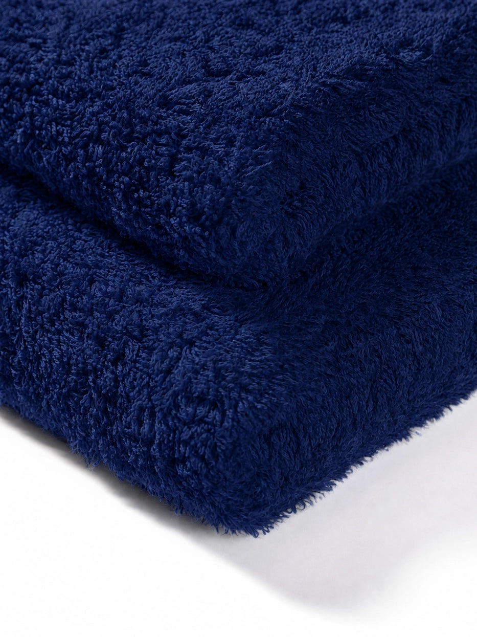 Extreme macro texture close-up of 100% cotton terry of R Collection navy blue face towel, full three-dimensional loop terry grain, clearly shows thick 200g heavyweight texture, soft skin-friendly cotton and fast water absorption, dense weave resistant to lint shedding and fading after repeated washes