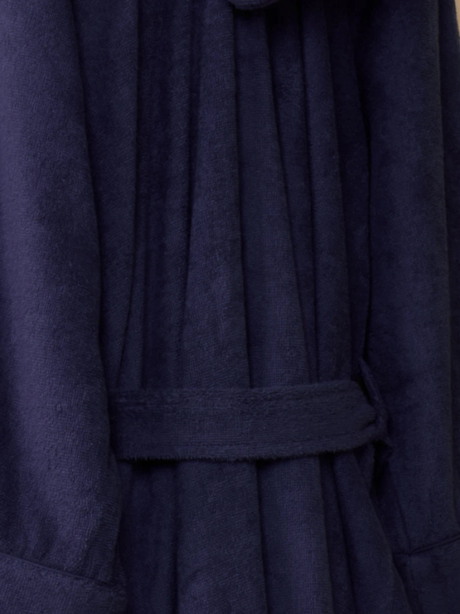 Extreme macro texture close-up of 100% cotton terry fabric of R Series bathrobe, thick full loop terry knit grain, clearly shows delicate soft cotton touch and fast water absorption performance, densely woven fabric resistant to lint shedding and hardening after washing