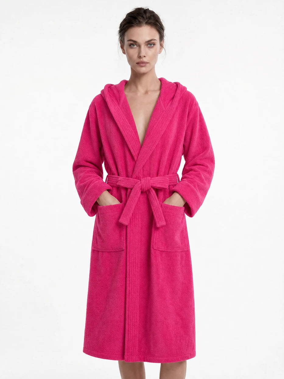 Pure white background full-body front shot of model wearing R Series rose red cotton hooded bathrobe, showing loose long well-fitted silhouette, fluffy soft terry texture, highlighting thick water-absorbent wearing experience of 100% cotton