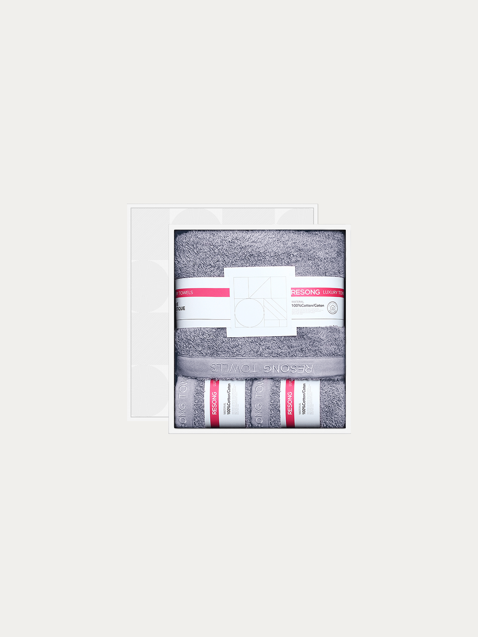 Official window gift box shot of R Series all-grey set (2 face towels + 1 bath towel) on pure off-white background, includes 2 grey face towels & 1 full-size grey bath towel, 100% cotton heavyweight thick terry, minimalist red label brand waist band, full bathroom gift set for men business & hotel matching