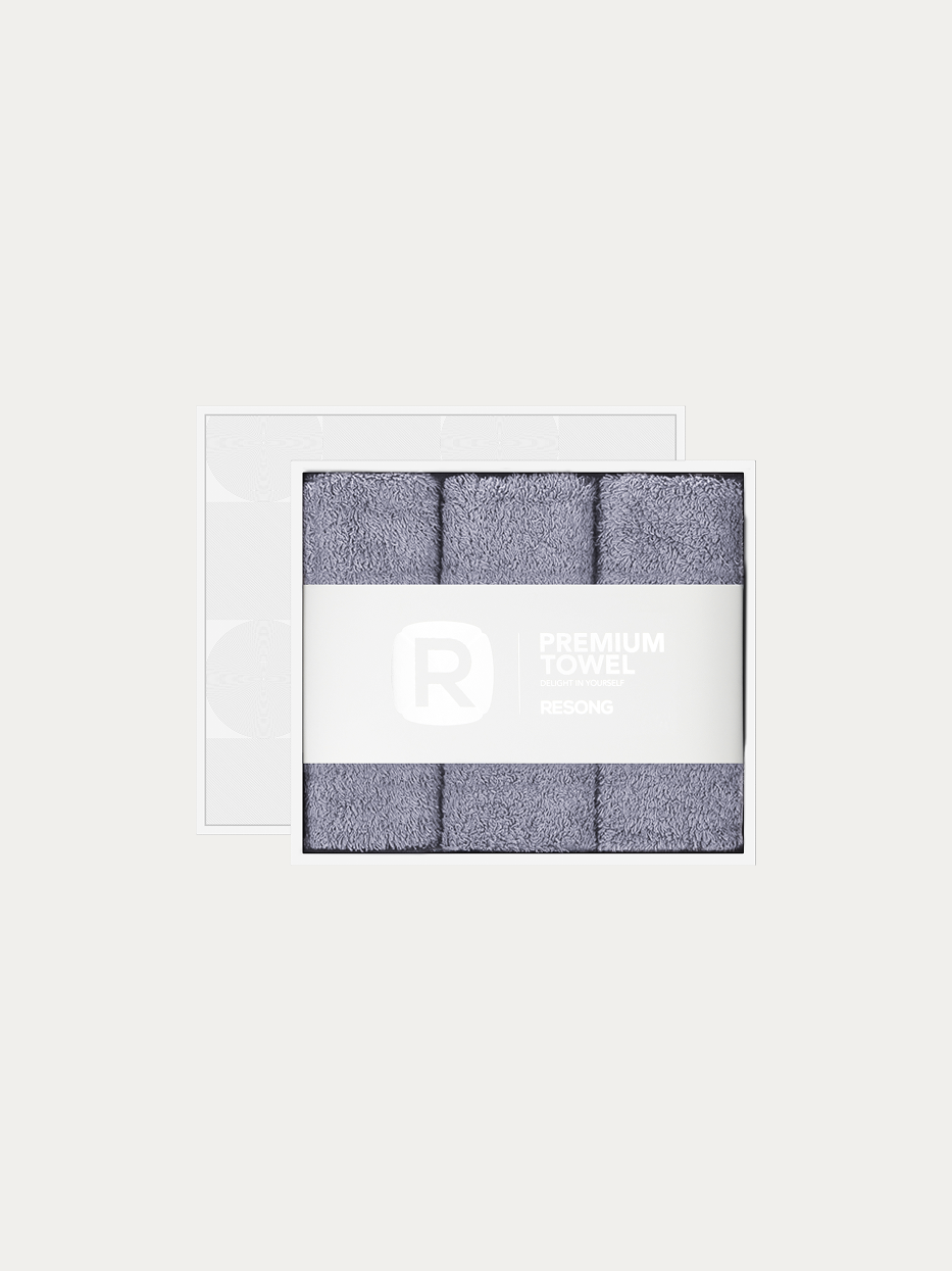 Official window gift box product shot of R Series all-grey 3pcs face towel set on pure off-white background, contains 3 grey cotton face towels, 200g heavyweight 100% cotton terry, minimalist RESONG brand waist band, neutral stain-resistant gift set for men business & hotel matching