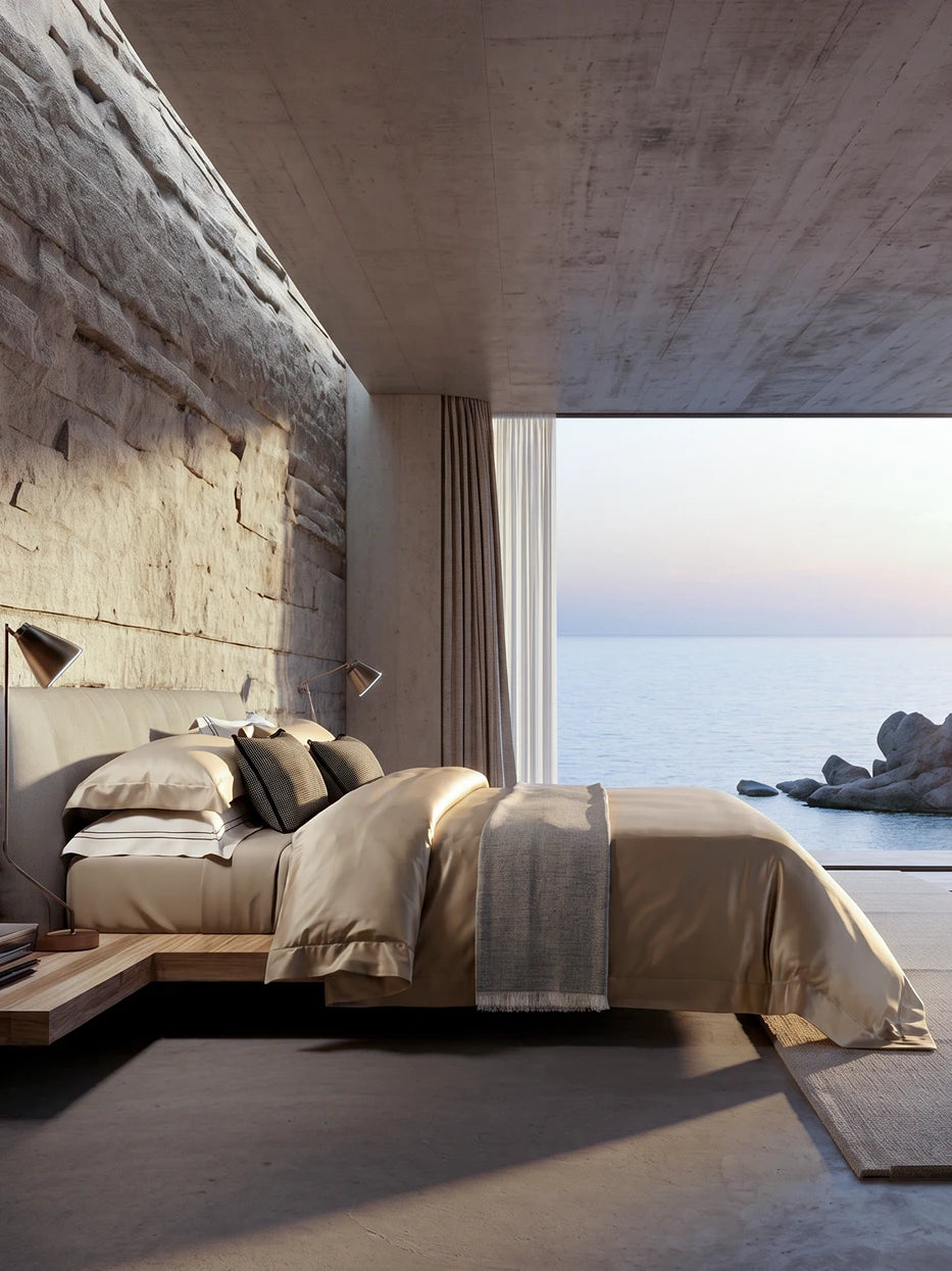 Coastal stone wabi sea-view bedroom furnishing full view shot of SHUMIAN champagne gold L-size silky bedding set beside floor-to-ceiling sea window