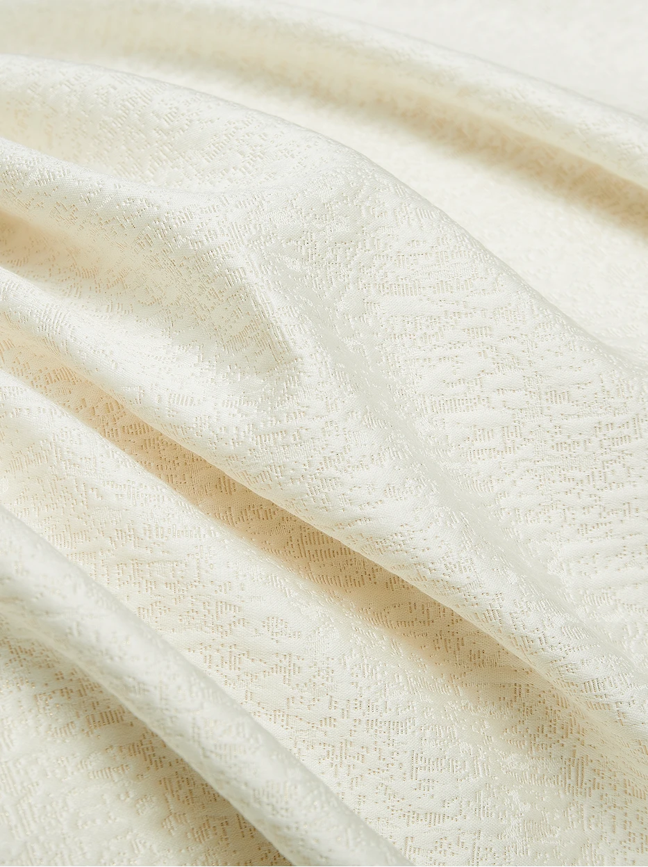 Soft natural light close-up shot of Vintage cream cotton fabric, showing three-dimensional subtle jacquard, tight thick 800TC weaving with matte soft luster