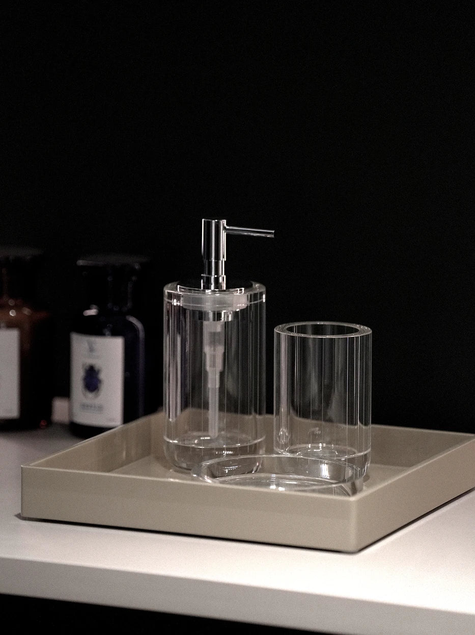 Dark minimalist bathroom furnishing shot of full XUYU crystal set (storage cup + lotion bottle + soap dish) on light beige leather vanity tray