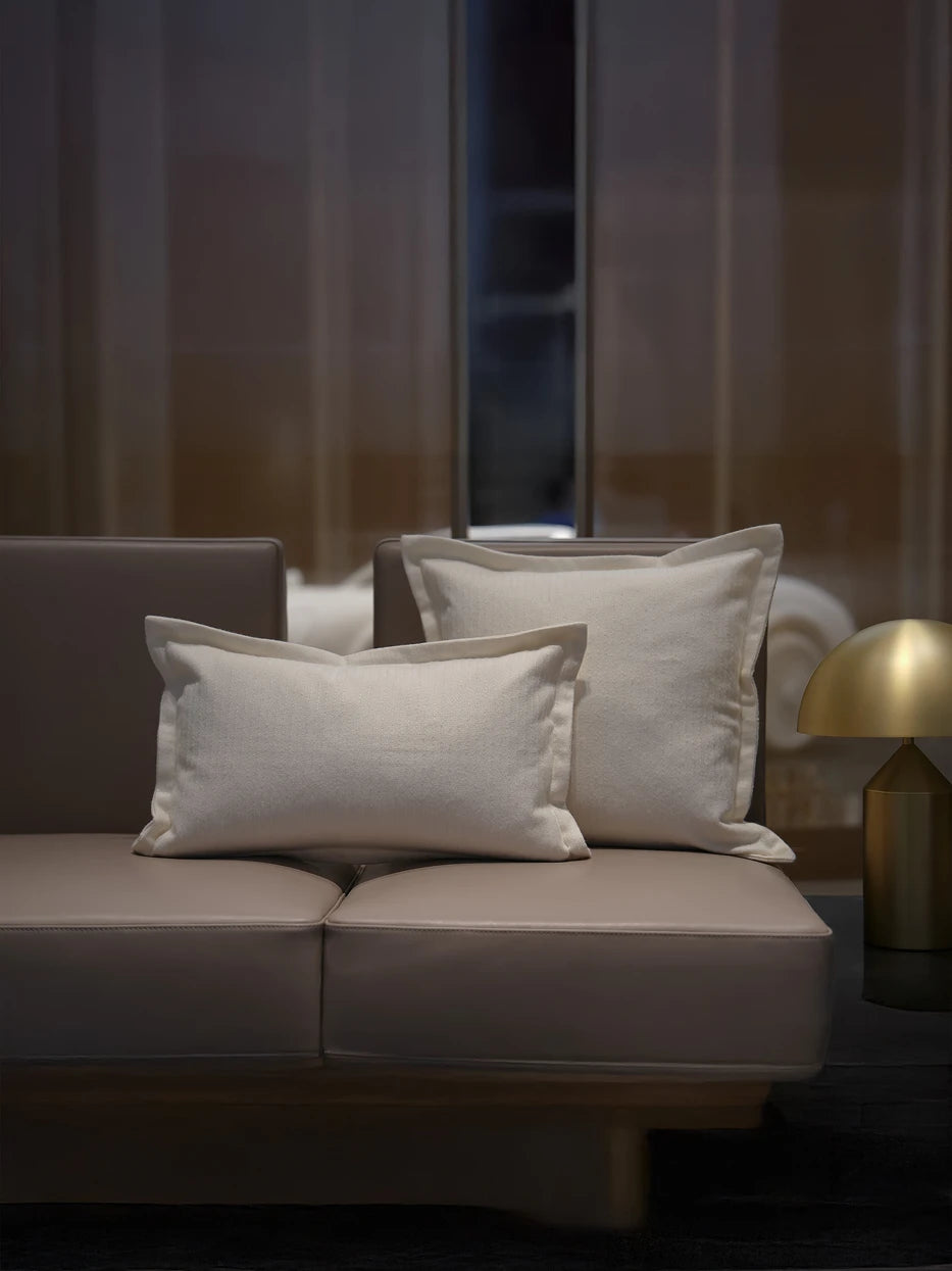 Minimalist living room matching furnishing layout shot, BERLIN white ribbed stripe lumbar pillow matched with same series square cushion on light brown leather sofa, unified vertical stripe texture enriches sofa visual layers, soft off-white matches all neutral home styles, premium complete set decor for villa lounge, club reception, large flat living room