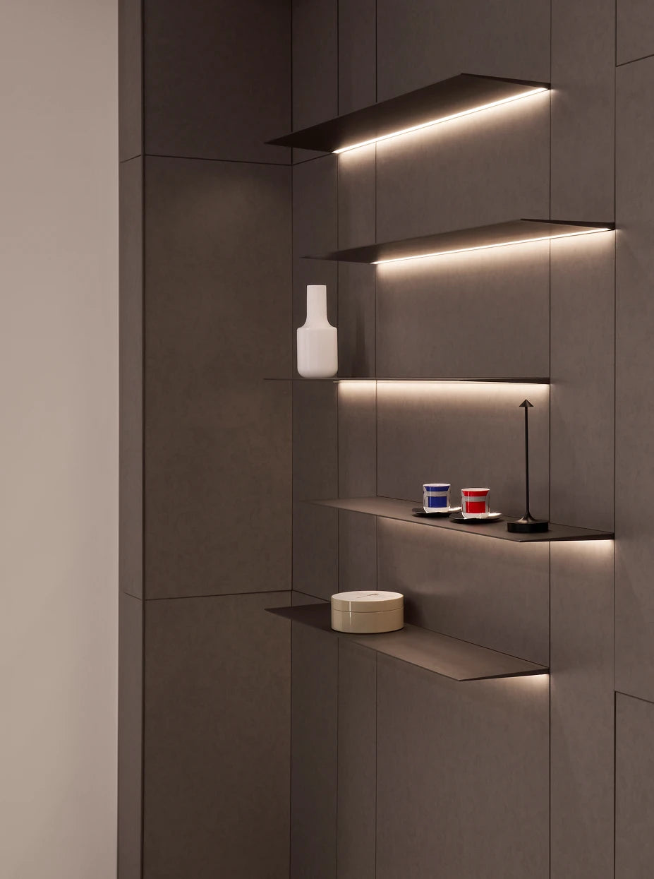 Dark tone study display furnishing shot of khaki storage box on lit floating dark wood shelf