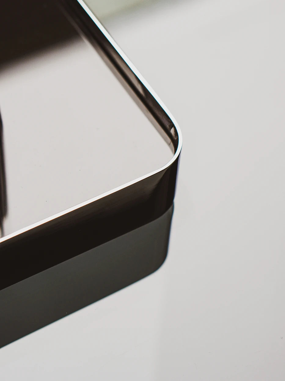 Craftsmanship close-up of rounded stainless steel wrapped edge, seamless one-piece high-polish smooth curved corner
