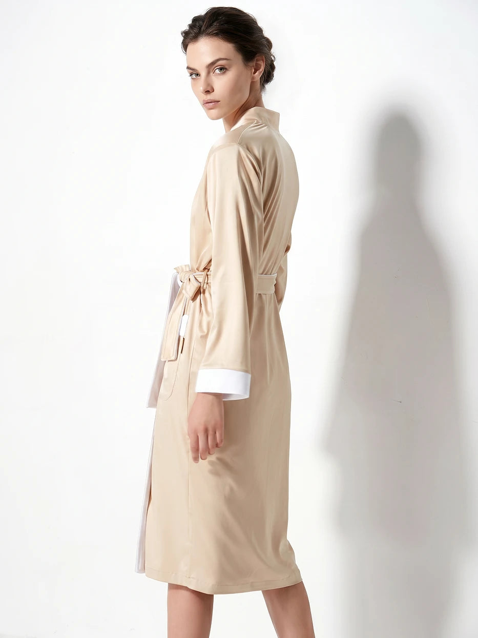 Pure white background full-body side shot of model wearing size M HERA amber double-layer bathrobe, showing moderate loose long silhouette, contrast white trim on lapel, cuffs and pockets, highlighting smooth draping outer fabric and well-fitted double-layer cut