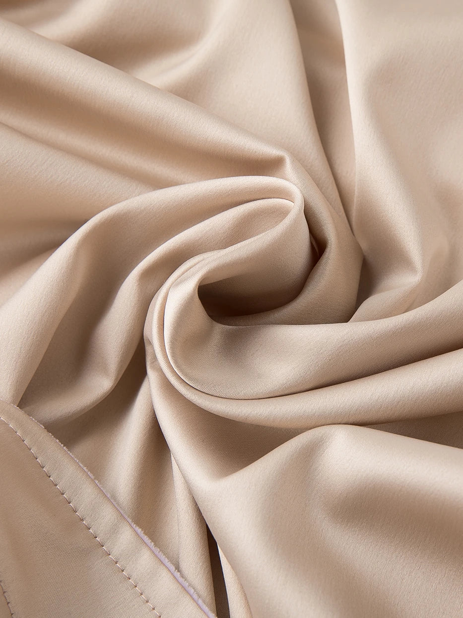 Extreme macro drape texture close-up of HERA bathrobe amber polyester outer fabric, soft matte satin grain, wrinkle-resistant draping fabric, fully presents gentle low-saturation amber premium luster