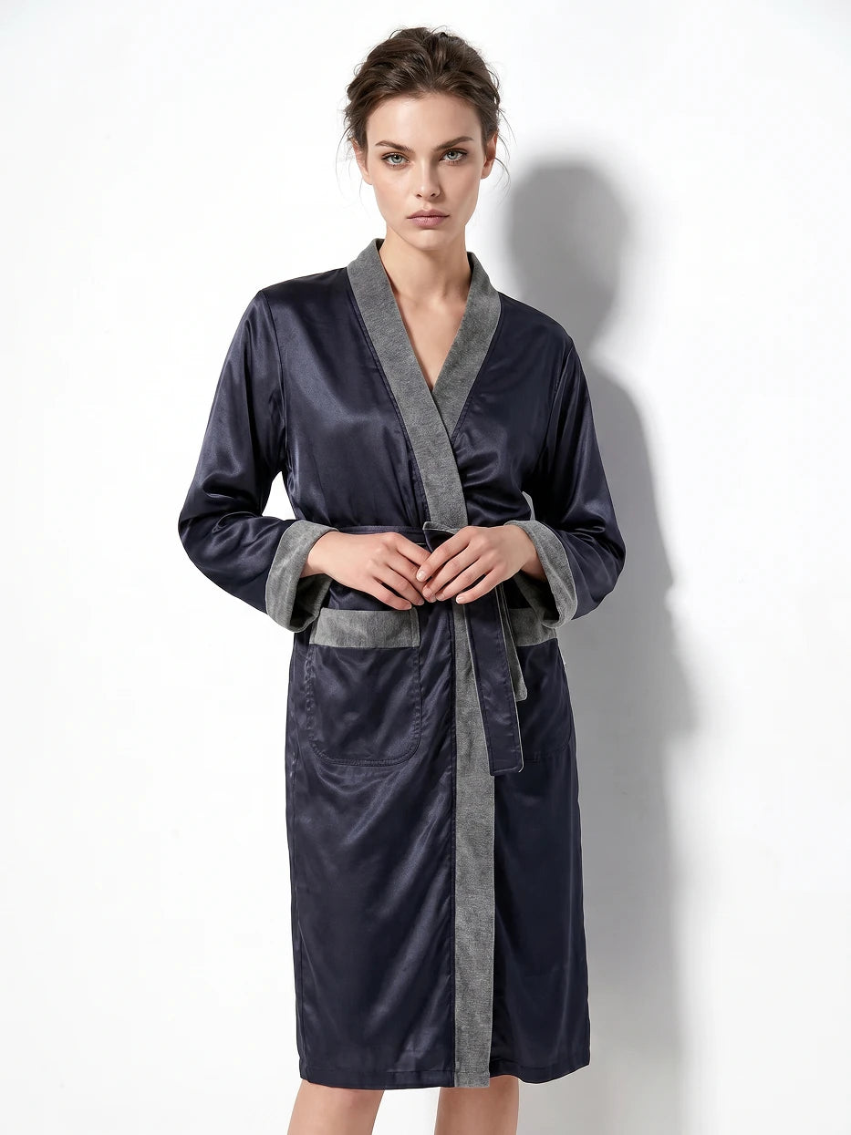 Pure white background half-body shot of model tying waist tie of HERA dark blue double-layer bathrobe, clearly shows matching wide fabric tie knot craft and contrast grey pocket detail, presents stiff smooth texture of double-layer fabric