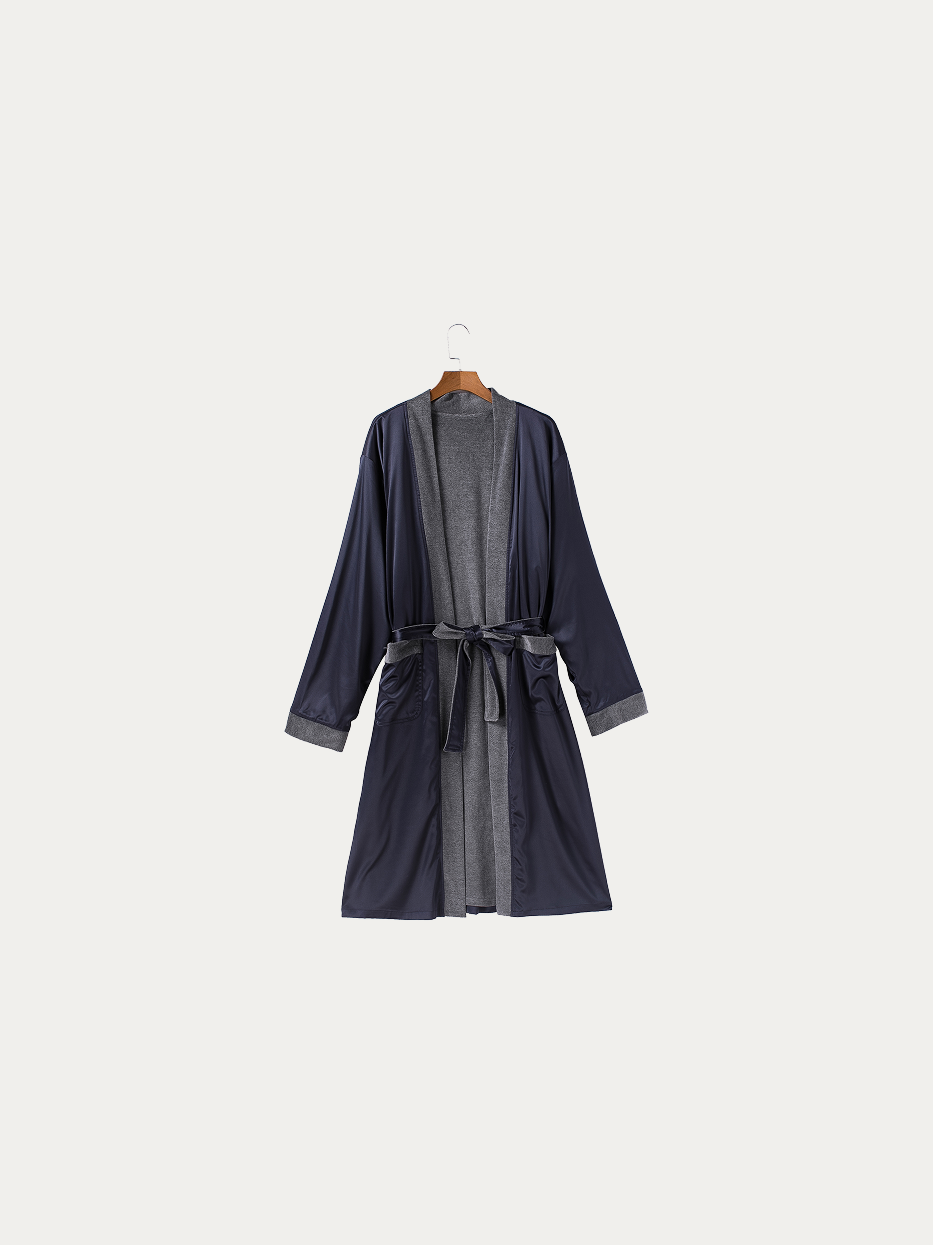 Official hanging product shot of HERA double-layer dark blue bathrobe size L on pure off-white background, smooth dark blue polyester outer fabric, inner 100% cotton grey terry lining, kimono V-collar, matching fabric waist tie, double side patch pockets, long dual-purpose bathrobe for home & hotel use