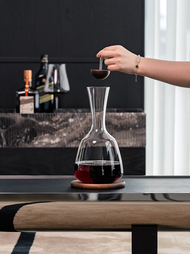 Official lifestyle image of the RESONG 1833 Decanter luxury crystal wine decanter displayed in a modern home bar, designed for elegant wine aeration, fine dining, and sophisticated entertaining.