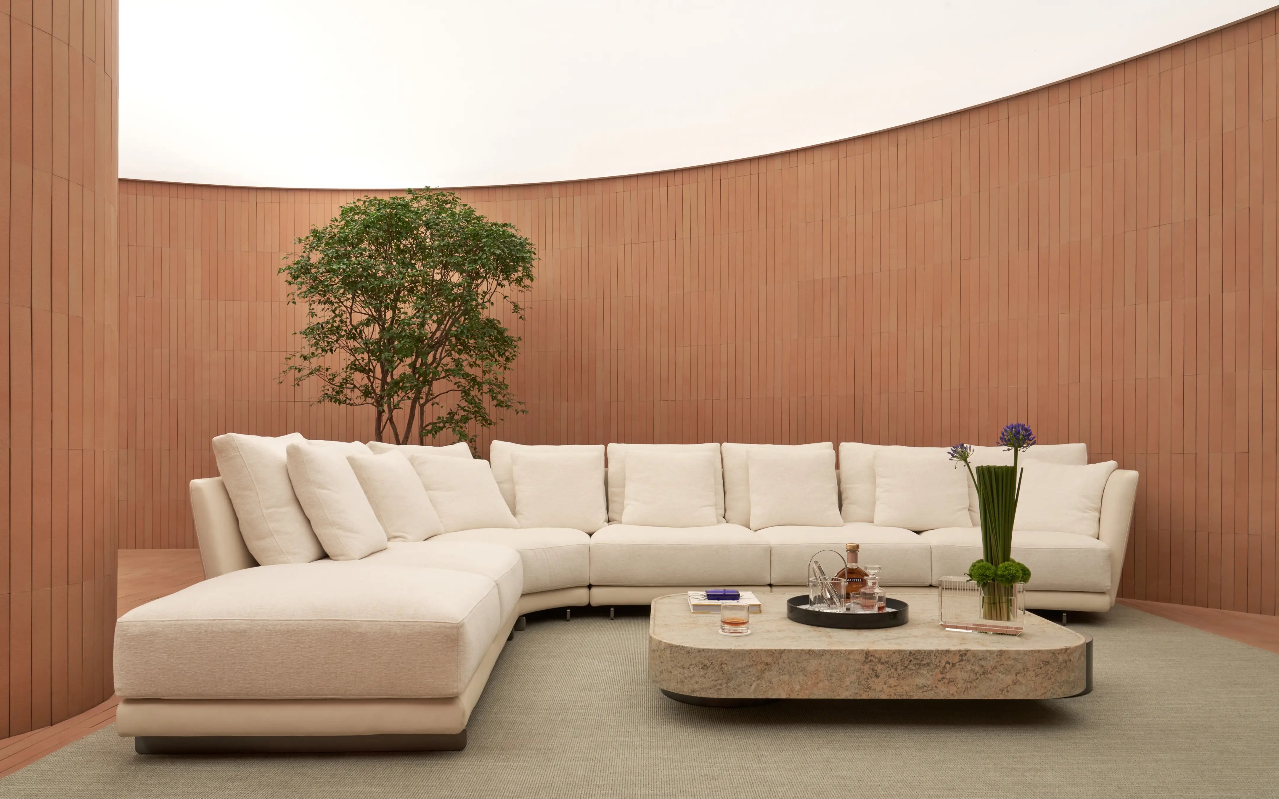 Modern luxury living room styled with RESONG HOME FILO Whiskey Collection, OPTICAL ART lacquer tray, GENTLEMAN crystal glasses, and XUYU high-transparency crystal cube vase on a contemporary stone coffee table.