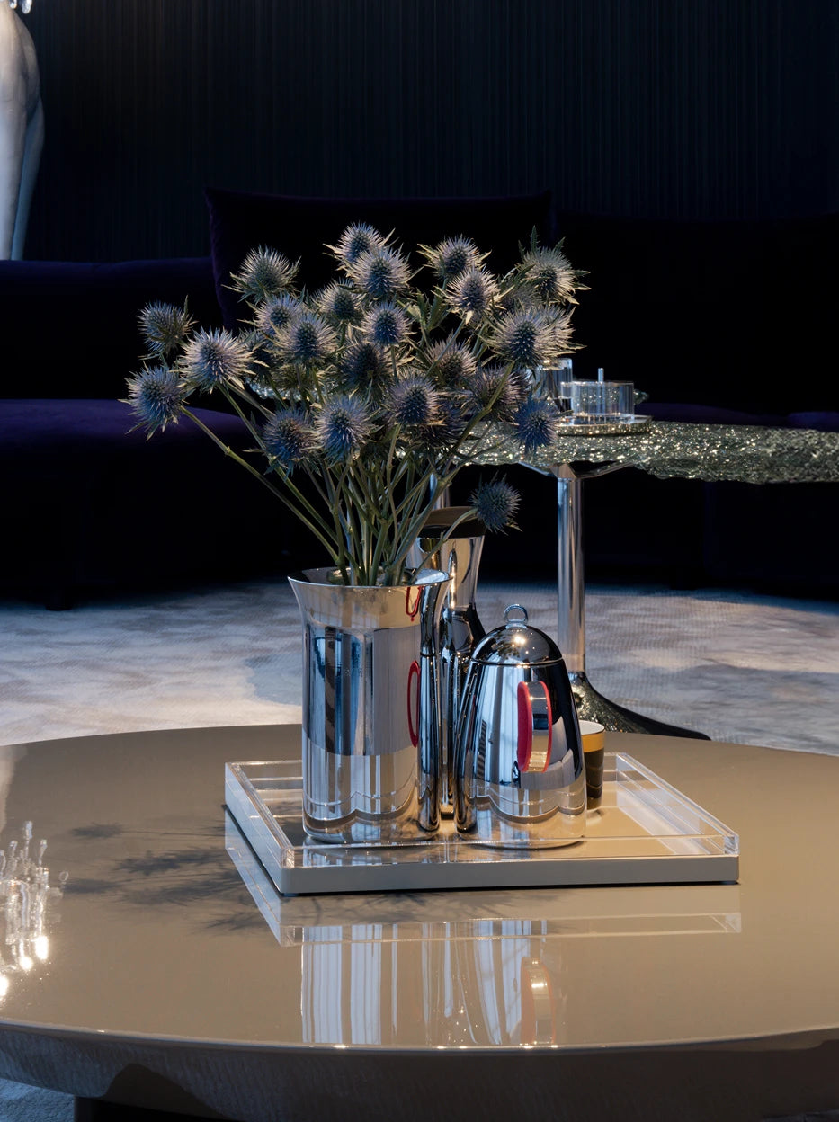 Living room decor matching shot of SHEDI wine bucket on transparent acrylic tray, paired with matching red handle teapot and eryngium dried flowers on reflective round coffee table