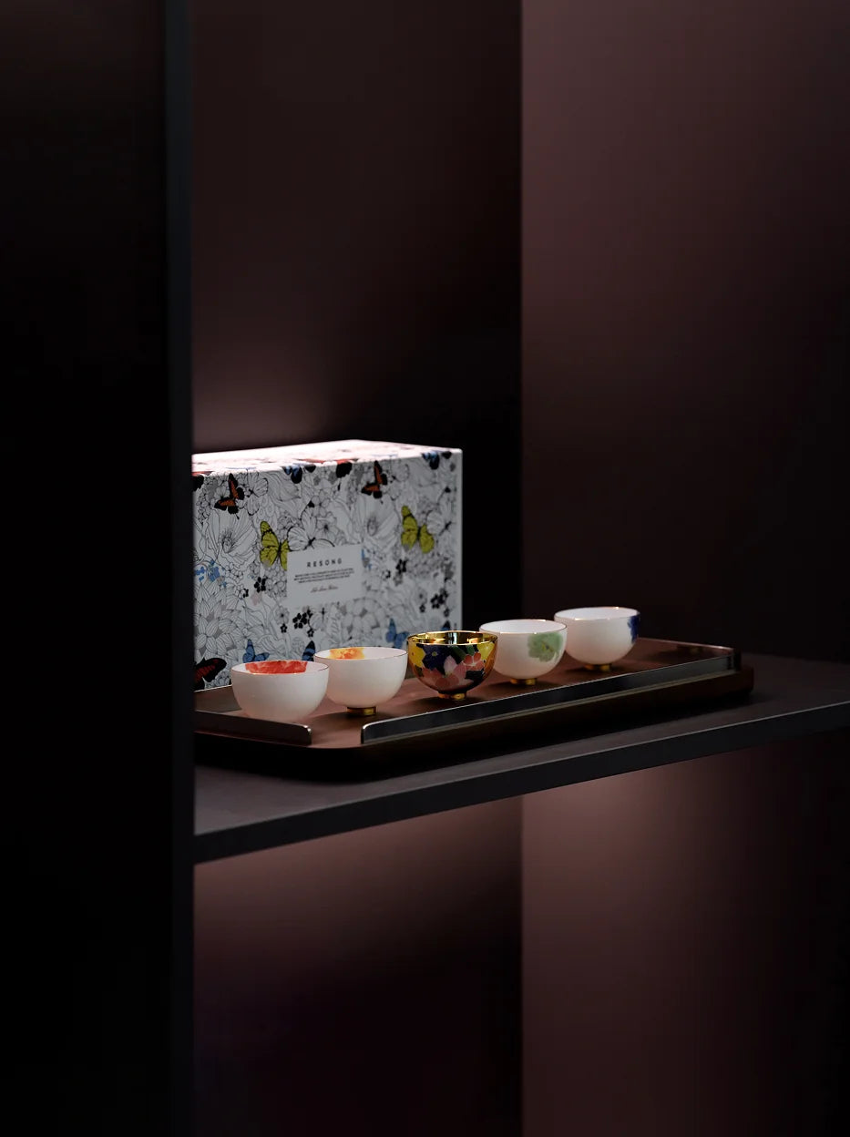 Premium gift display shot of full five-piece underglaze cup set on dark shelf, matched with butterfly printed flip gift box for holiday gift display
