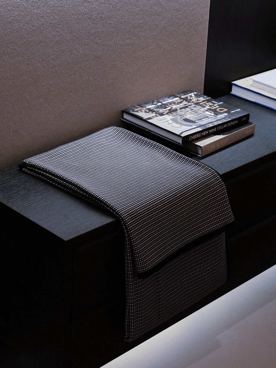 Light luxury study furnishing layout shot, LUODI tiny check cashmere throw draped over dark solid wood side cabinet, matched with matte dark wall, retro fine check texture adds delicate layered detail to heavy dark furniture, premium decor for villa study, club lounge, large flat study, dark neutral tone interior styling