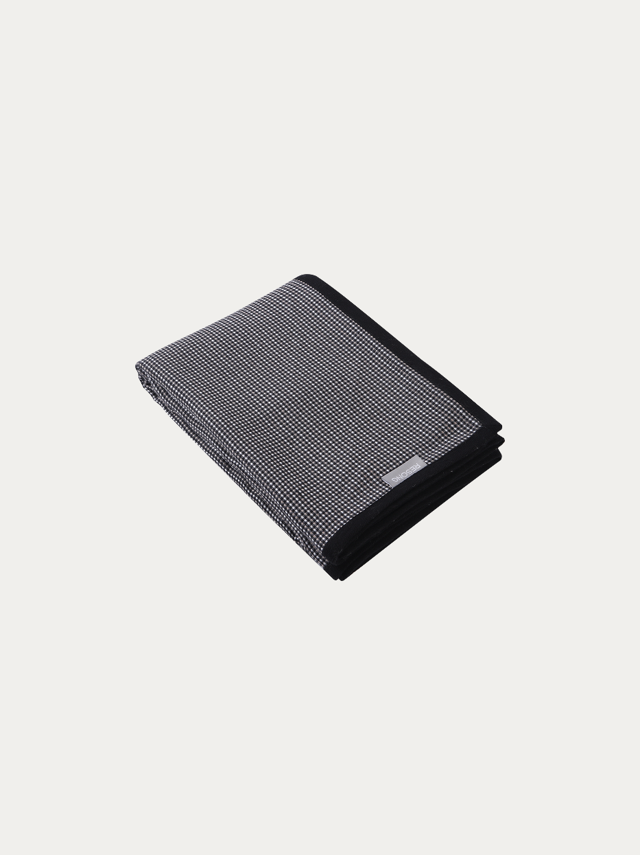 Official flat lay product shot of LUODI black white check cashmere blanket on pure off-white background, oversized 1400x2000 throw blanket with delicate tiny check woven texture, full black contrast finished edge, blended fabric of 20% wool and 80% viscose, silky soft multi-purpose decorative cover, ideal for sofa, bed end, window bench, office nap shawl, travel wrap, fits modern light luxury, retro, minimalist, dark tone interior decor
