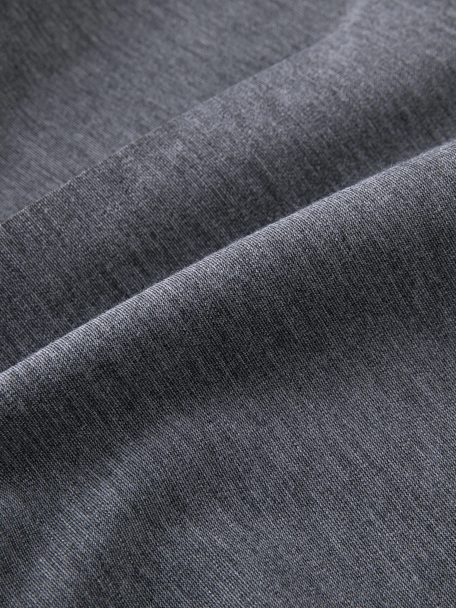 Extreme macro texture close-up of MAYA stretch silk cotton bathrobe fabric, dense heather gray mixed knit grain, clearly shows soft silk cotton luster and high stretch rebound performance, lightweight breathable without stuffy thick texture