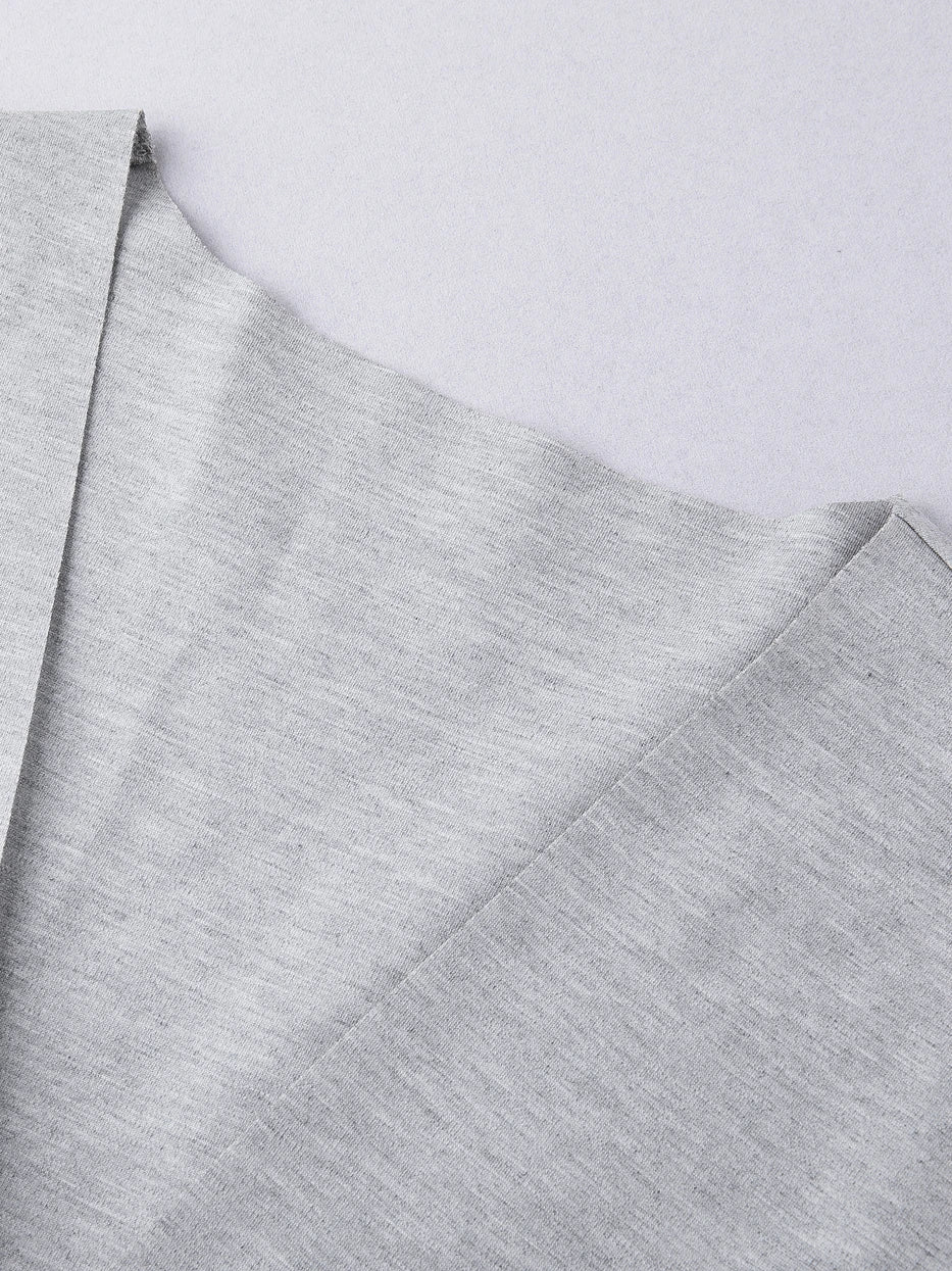 Macro close-up of kimono V-lapel joint of MAYA stretch bathrobe, integrated solid fabric seamless splicing craft, neat uniform fine lock stitching, displays precise well-fitted minimalist craft of single-layer knit fabric