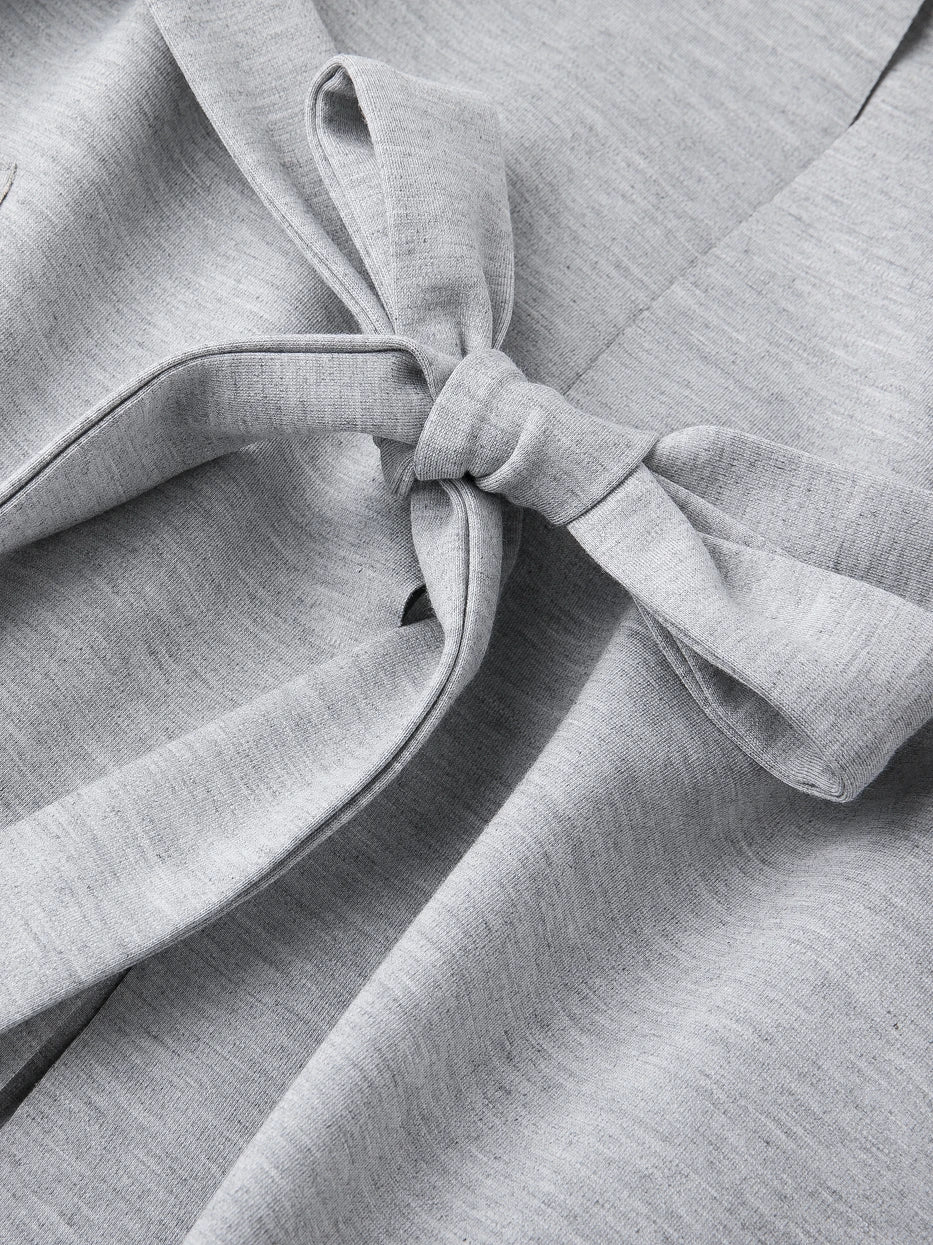 Macro close-up of wide matching fabric waist tie knot of MAYA stretch bathrobe, integrated stretch light heather gray knit fabric, anti-slip tight knot design, fully presents fabric stretch draping texture and neat full wrapped edge craft