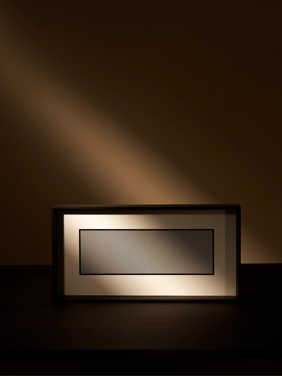 Quiet minimalist texture still life shot of empty black long tray on dark wood table, warm side light highlighting glossy lacquer and inner geometric texture