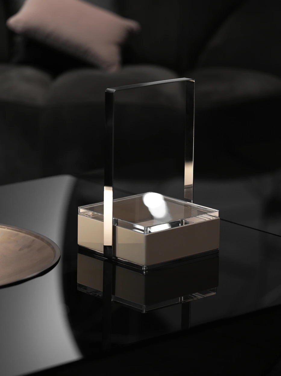 Dark tone minimalist living furnishing shot of PAIS small box on reflective black glass coffee table