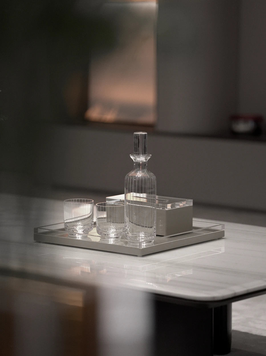 Minimalist tea room furnishing shot of khaki PAIS square tray on white marble coffee table matched with vertical striped glass tableware