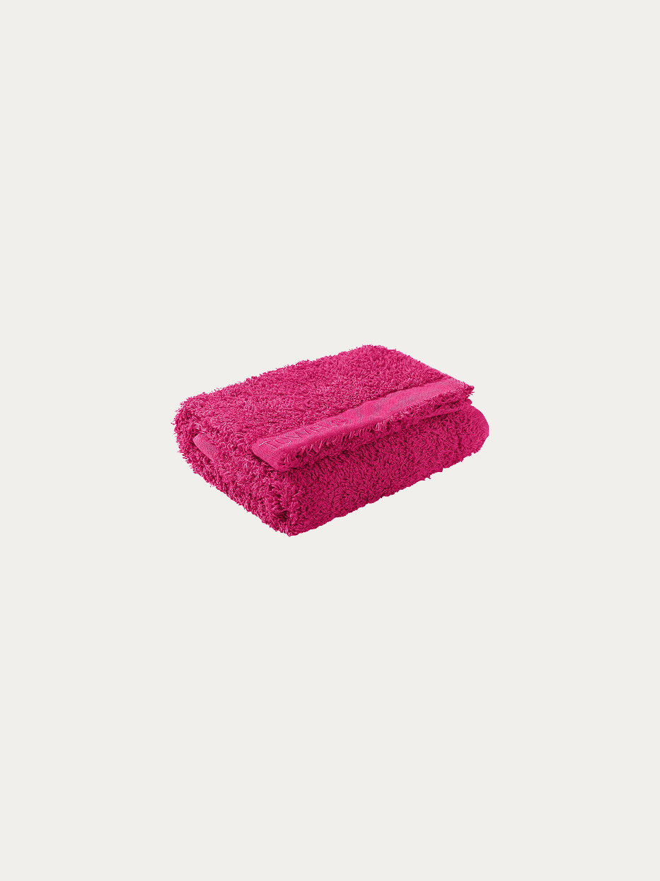 Official folded product shot of R Collection rose red cotton face towel on pure off-white background, oversized 750×410mm, 200g heavyweight thick terry, woven band embroidered with TOWELS logo, eye-catching water-absorbent facial towel for homestay & gift box matching