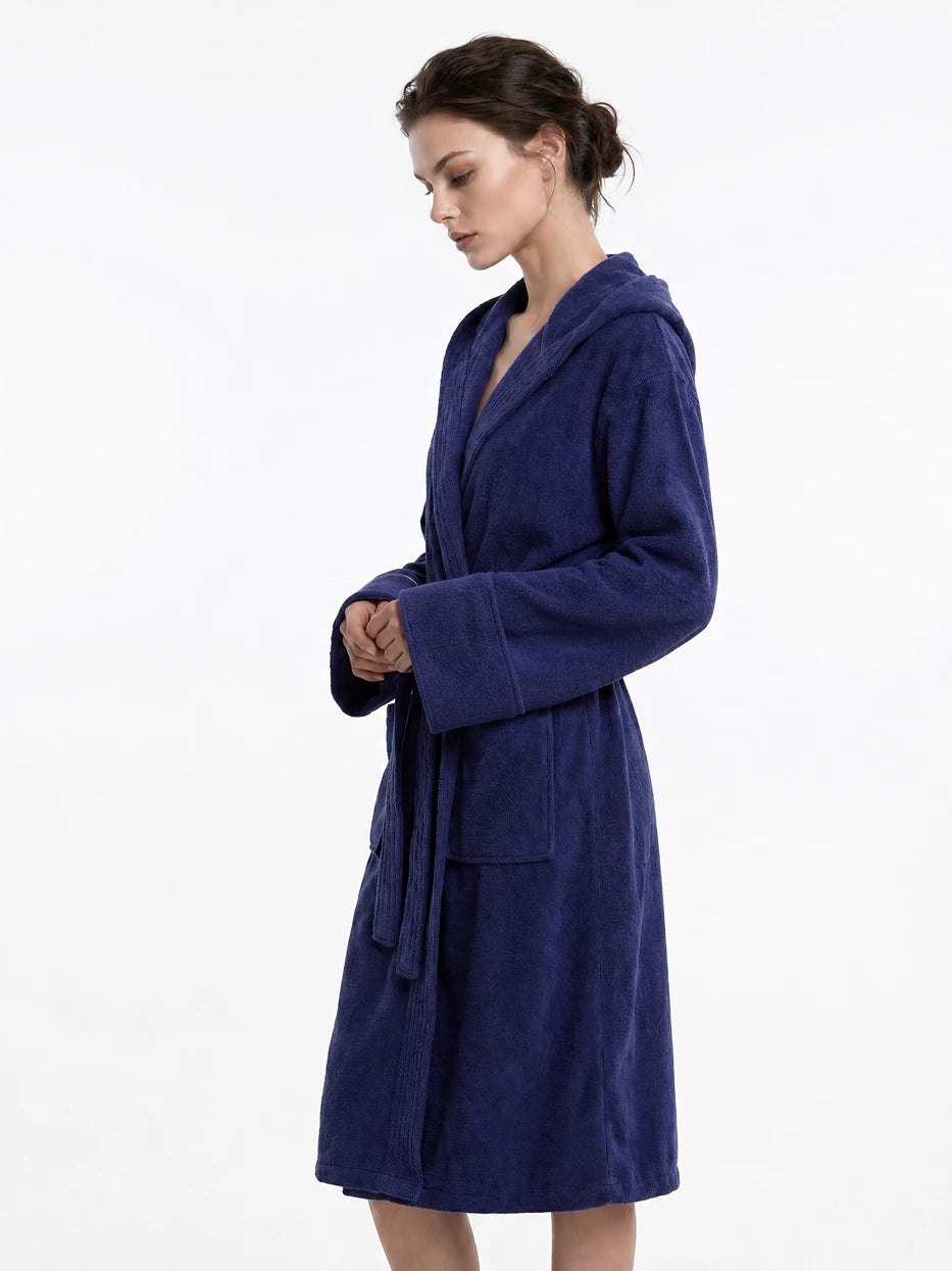 Pure white background half-body side shot of model wearing R Series navy blue cotton hooded bathrobe, clearly displays V-neck lapel, adjustable waist tie and folded wide cuff details, presents soft draping wearing effect of cotton terry fabric