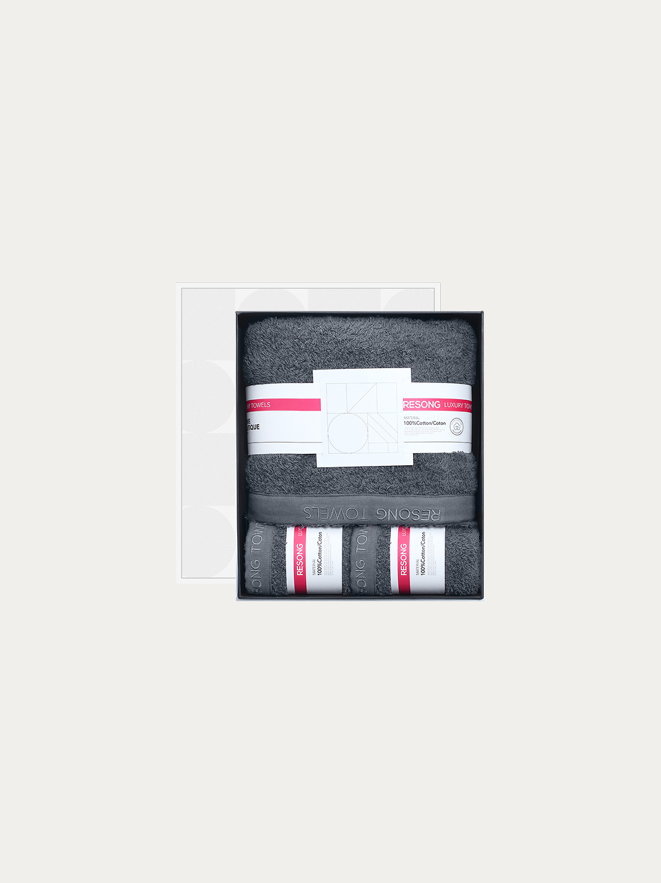 Official window gift box shot of R Series all-grey set (2 face towels + 1 bath towel) on pure off-white background, includes 2 grey face towels & 1 full-size grey bath towel, 100% cotton heavyweight thick terry, minimalist red label brand waist band, full bathroom gift set for men business & hotel matching