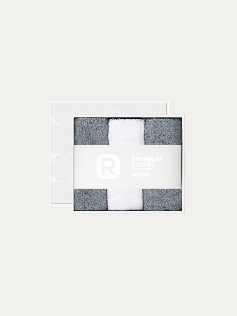 Official window gift box product shot of R Series 2 grey + 1 white face towel set on pure off-white background, contains 2 grey & 1 white cotton face towels, 200g heavyweight 100% cotton terry, minimalist RESONG brand waist band, unisex neutral premium gift set for daily gifting