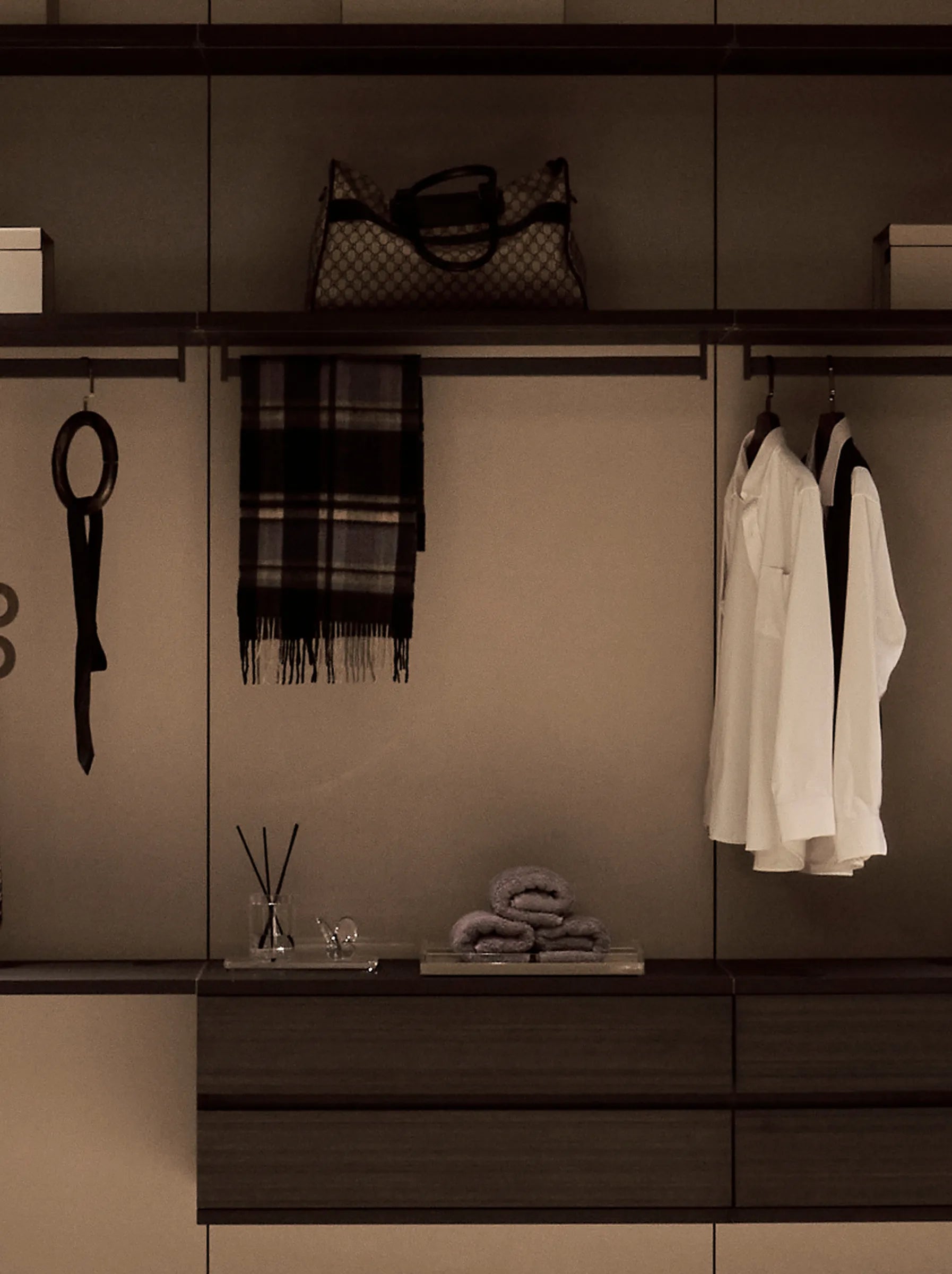 Walk-in closet detail featuring the RESONG R Towel Collection, XUYU Bath Collection, Butterfly Collection and Crystal Long Tray, showcasing refined organization and luxury home styling.