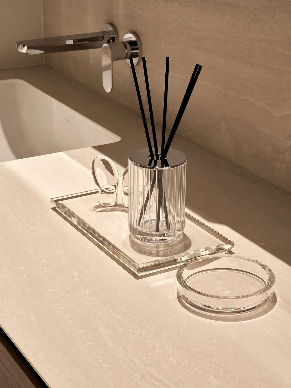 Cream minimalist bathroom furnishing shot of XUYU soap dish matched with striped crystal diffuser beside travertine wash basin