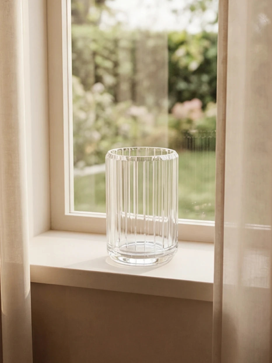 Soft natural light furnishing shot of XUYU crystal cup on white window sill with sheer curtain backdrop
